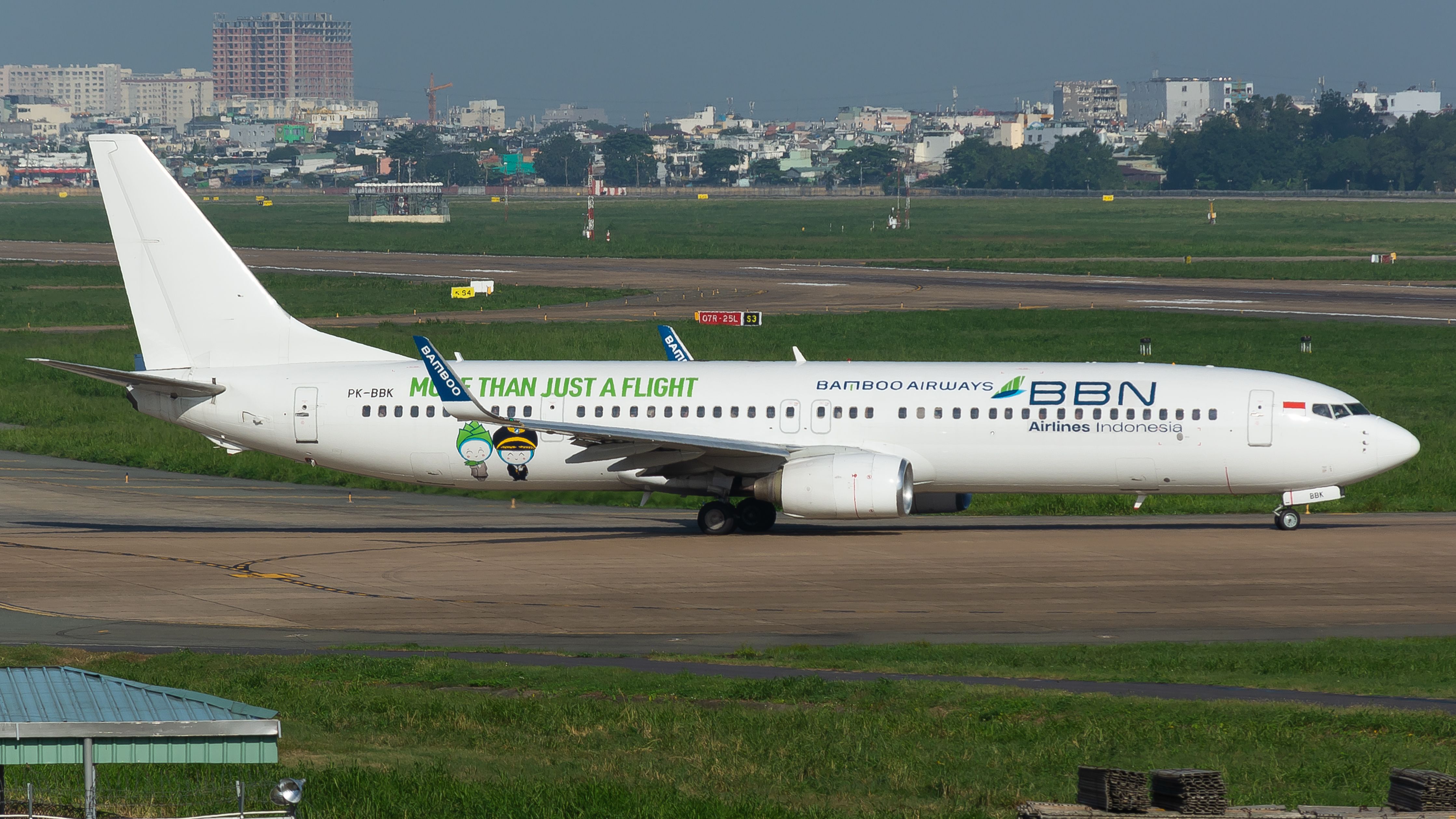 Bamboo Airways Boeing 737 taxiing on a runway at an airport on a clear day.