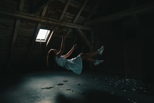 Woman in White Dress Falling on Gray Concrete Floor