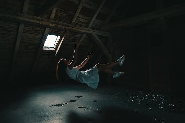 Woman In White Dress Falling On Gray Concrete Floor