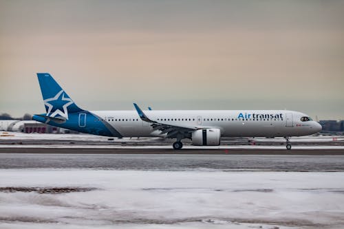 Passenger aircraft moving on airfield after landing in airport during sunset on winter day