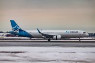 Passenger aircraft moving on airfield after landing in airport during sunset on winter day