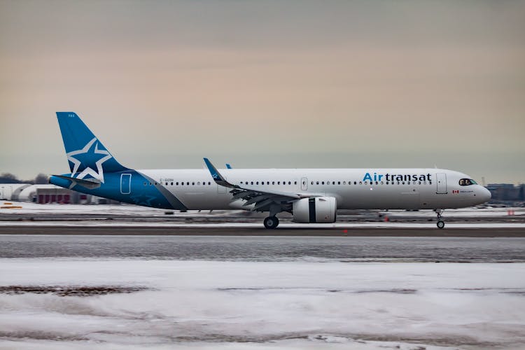 Airplane Driving On Airport Runway During Sundown