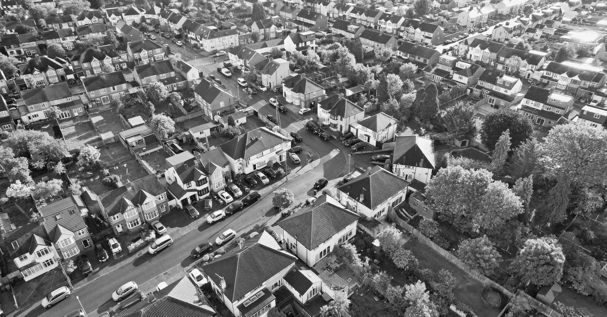 Black and white aerial image of a suburban residential area in Luton, showcasing tightly packed houses and streets.