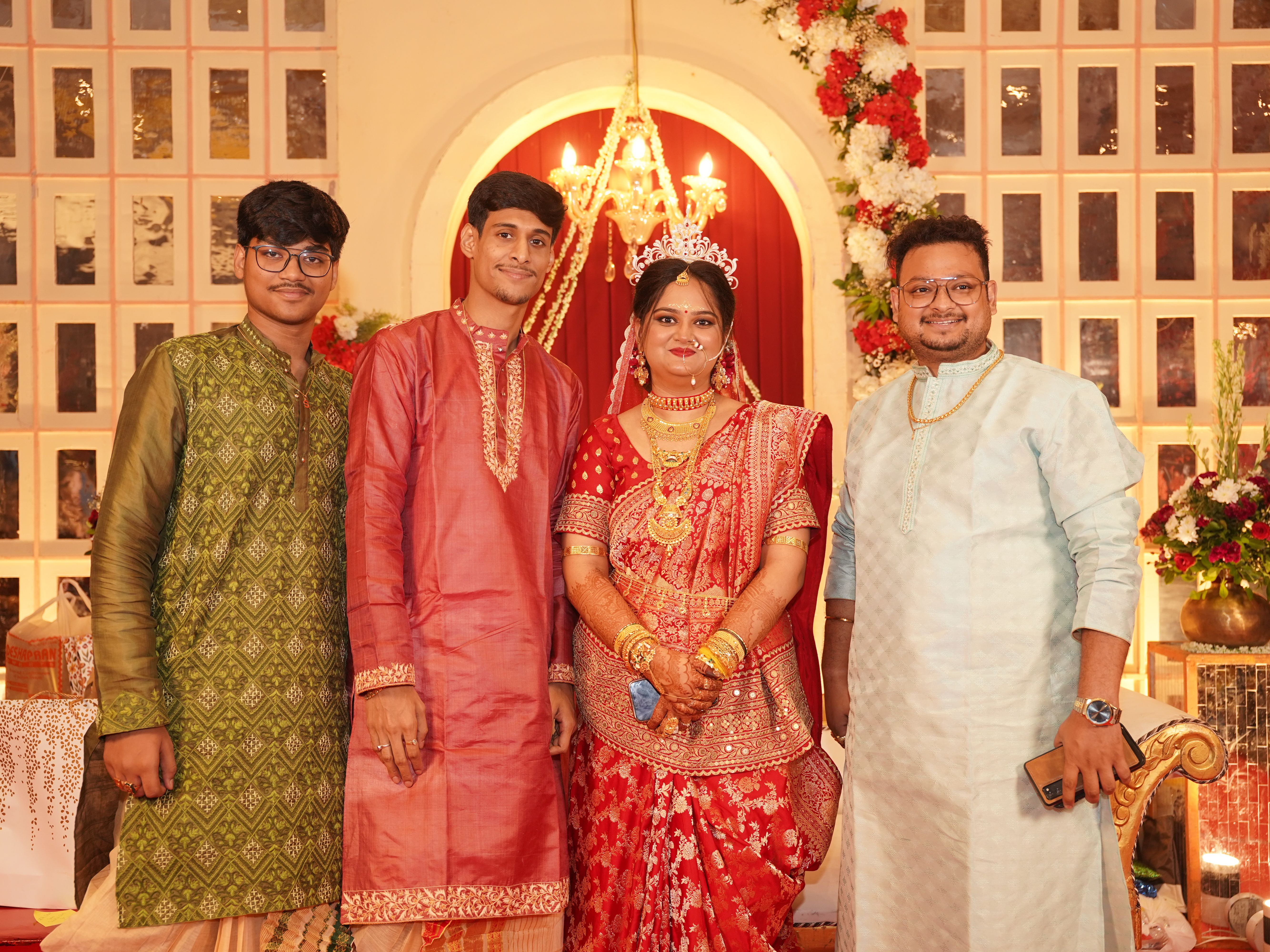 A vibrant Bengali wedding in Kolkata featuring a bride in red saree and floral decor.