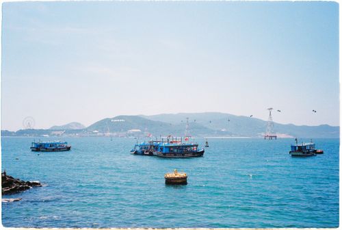 Free A peaceful summer day with boats on the ocean in Nha Trang, Vietnam, under a clear blue sky. Stock Photo