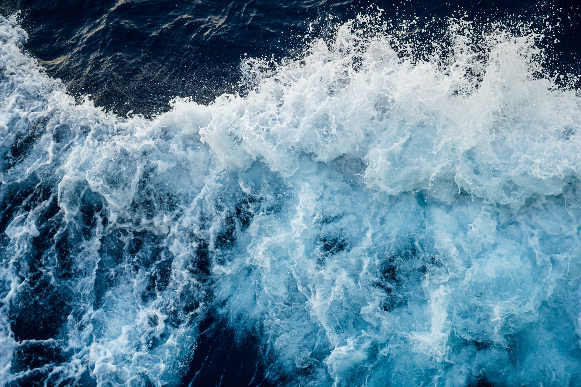 Aerial view of powerful ocean waves crashing with intense energy and frothy textures. — free online jigsaw puzzle on JigsawPuzzlesFreeOnline.org
