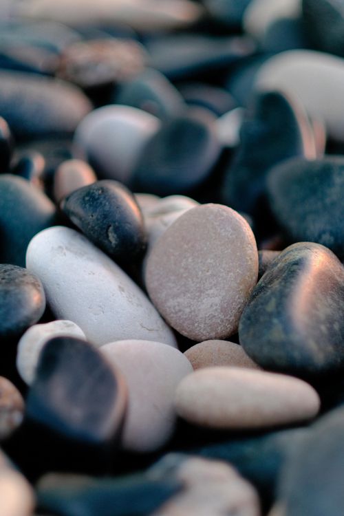 Free A detailed close-up image of smooth, multicolored river pebbles in Limassol, Cyprus. Stock Photo