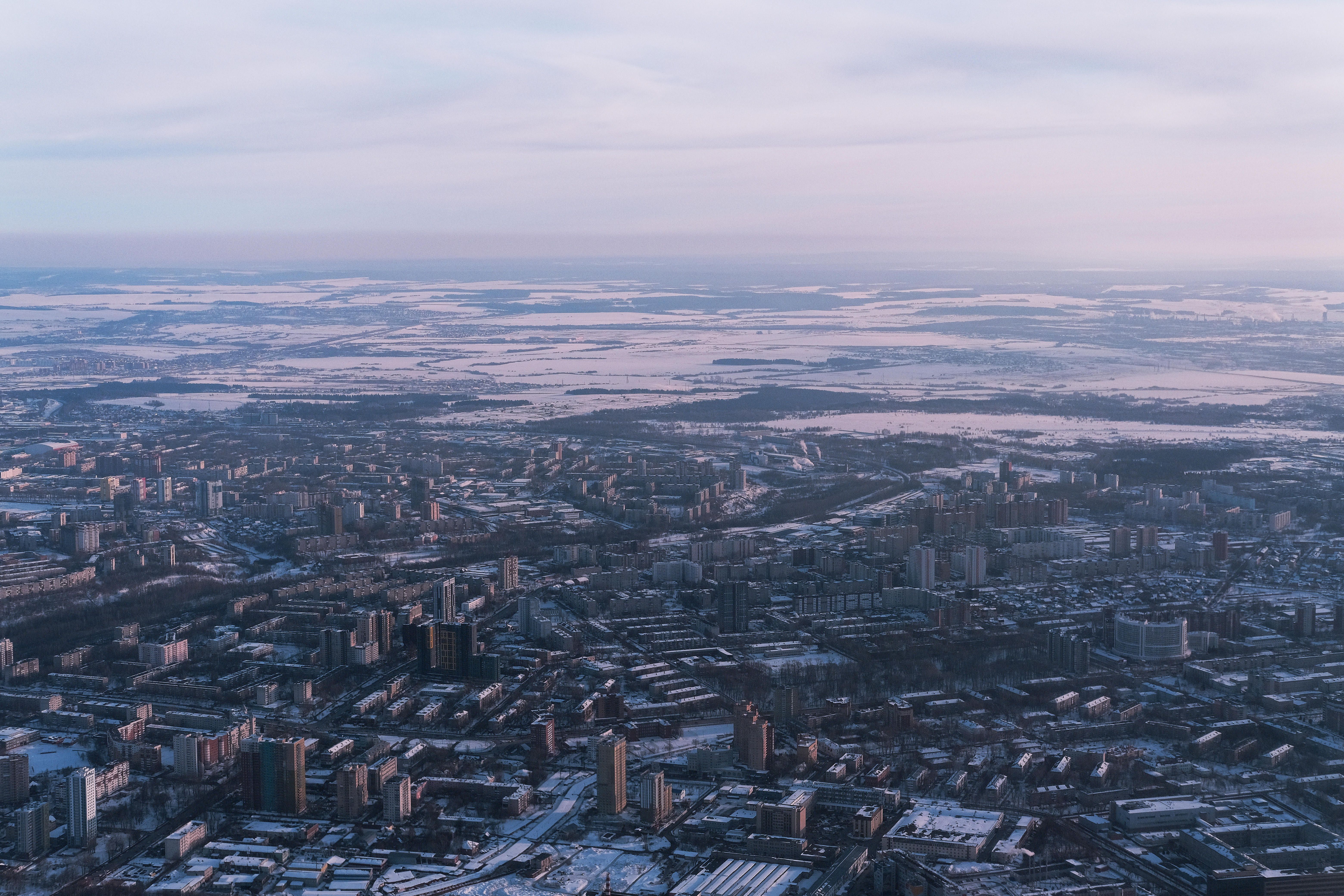 Stunning aerial view of the cityscape of Perm, Russia during winter, showcasing snow-covered urban architecture.