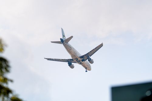 Free Commercial airplane flying overhead with clear sky in Sepang, Malaysia. Stock Photo