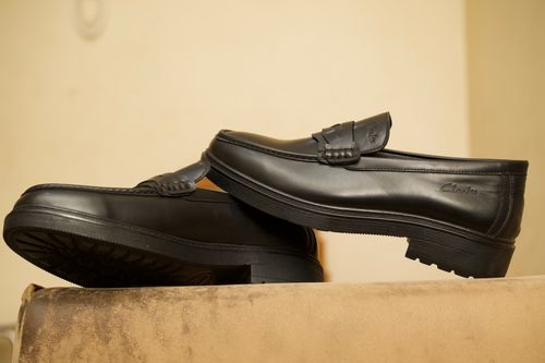 Free High-quality black leather loafers with a sleek design, perfect for formal and smart casual wear. Stock Photo