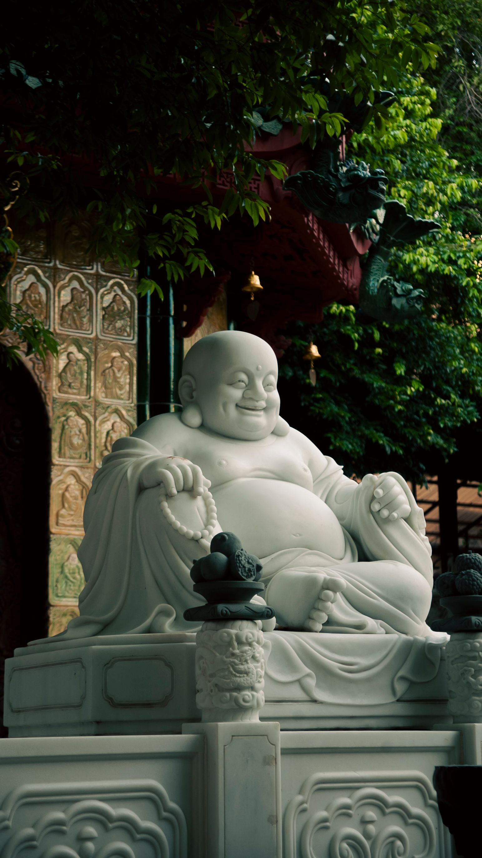 White Buddha statue in Ho Chi Minh City garden temple.