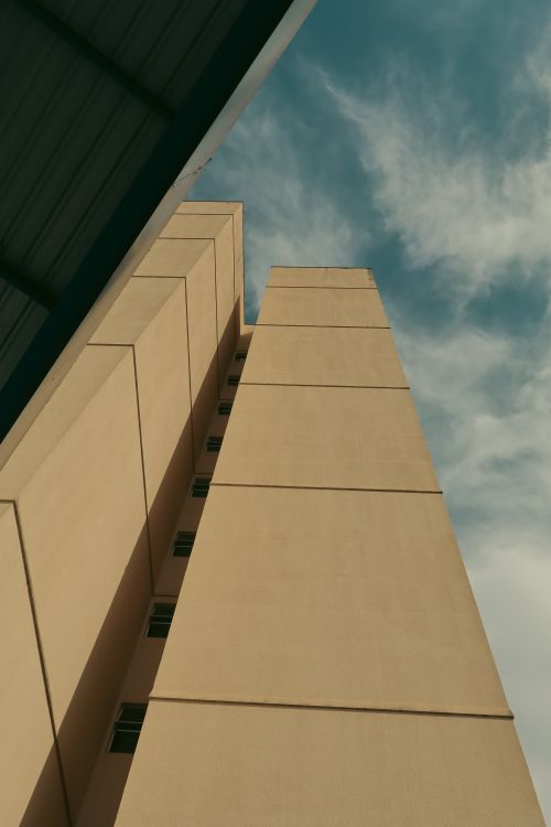 Free Low angle view of a modern building under a blue sky with clouds in Goiás, Brazil. Stock Photo