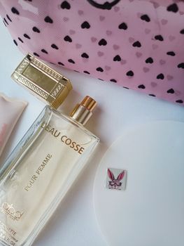 Elegant flat lay of Eau Cosse perfume with chic accessories for a fashionable look.