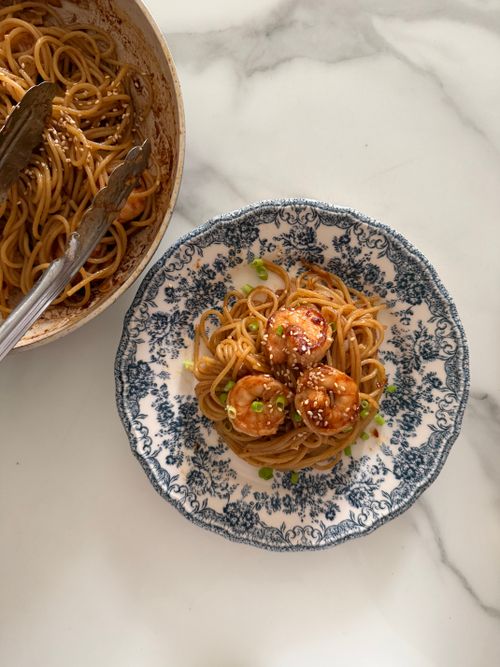 Free Appetizing plate of spaghetti with shrimp garnished with sesame seeds and green onions. Stock Photo