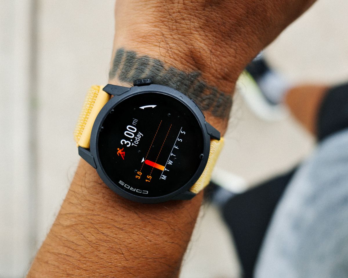 Close-up of a smartwatch tracking a runner's heart rate and distance during a 3-mile run