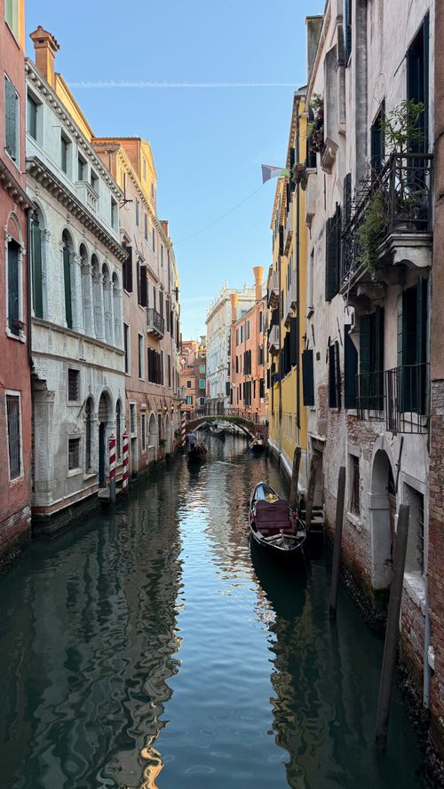 Free Beautiful canal scene in Venice, Italy with gondolas and historic architecture at dawn. Stock Photo