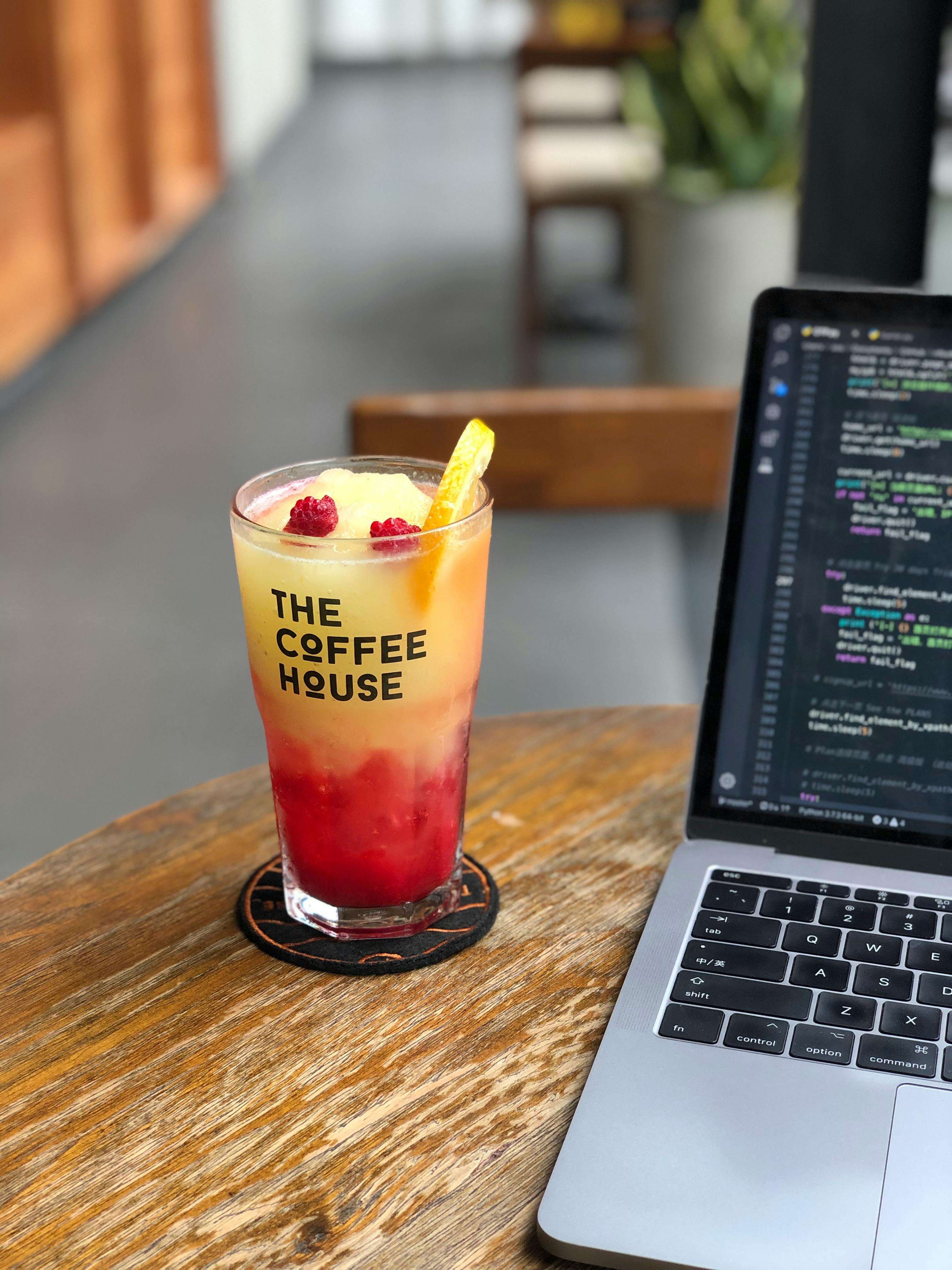 a beverage beside a laptop