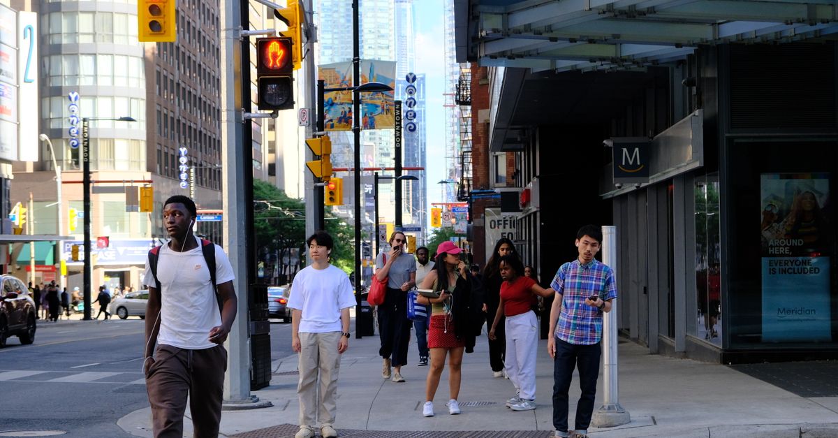 International students walking a Canadian campus under the new study permit cap