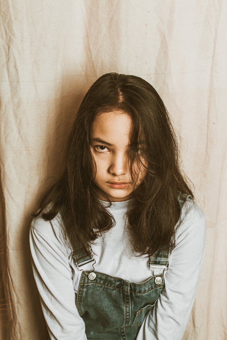 Unhappy Asian Teen Girl Looking At Camera