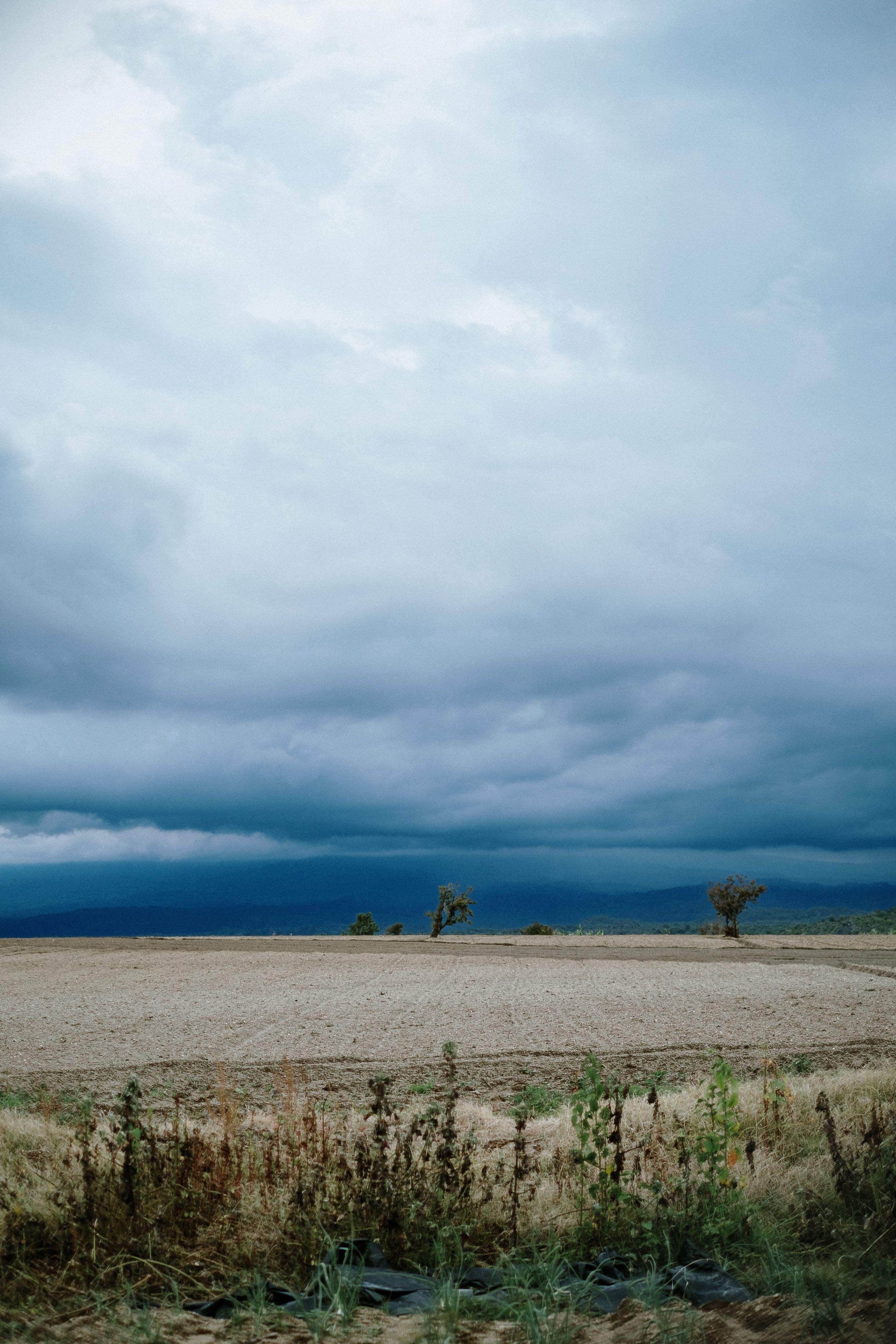 Dramatic storm clouds over an empty field in Puebla, Mexico, capturing nature's power.. pexels, dramatic, storm