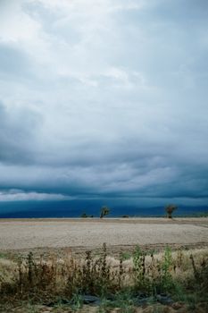 Dramatic storm clouds over an empty field in Puebla, Mexico, capturing nature's power.. pexels, dramatic, storm