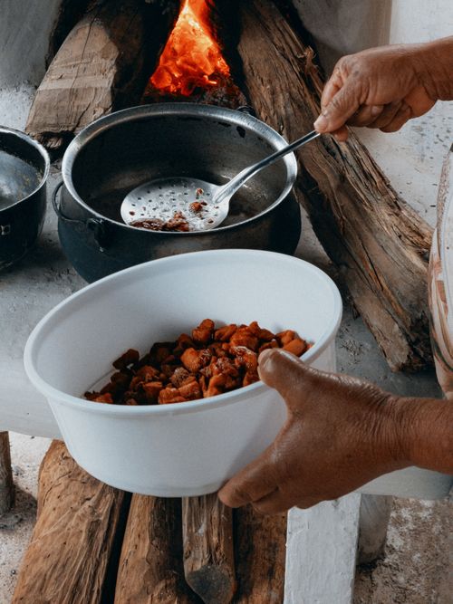 Free A person cooking in Brazil using a wood stove, showcasing natural culinary skills and rustic methods. Stock Photo