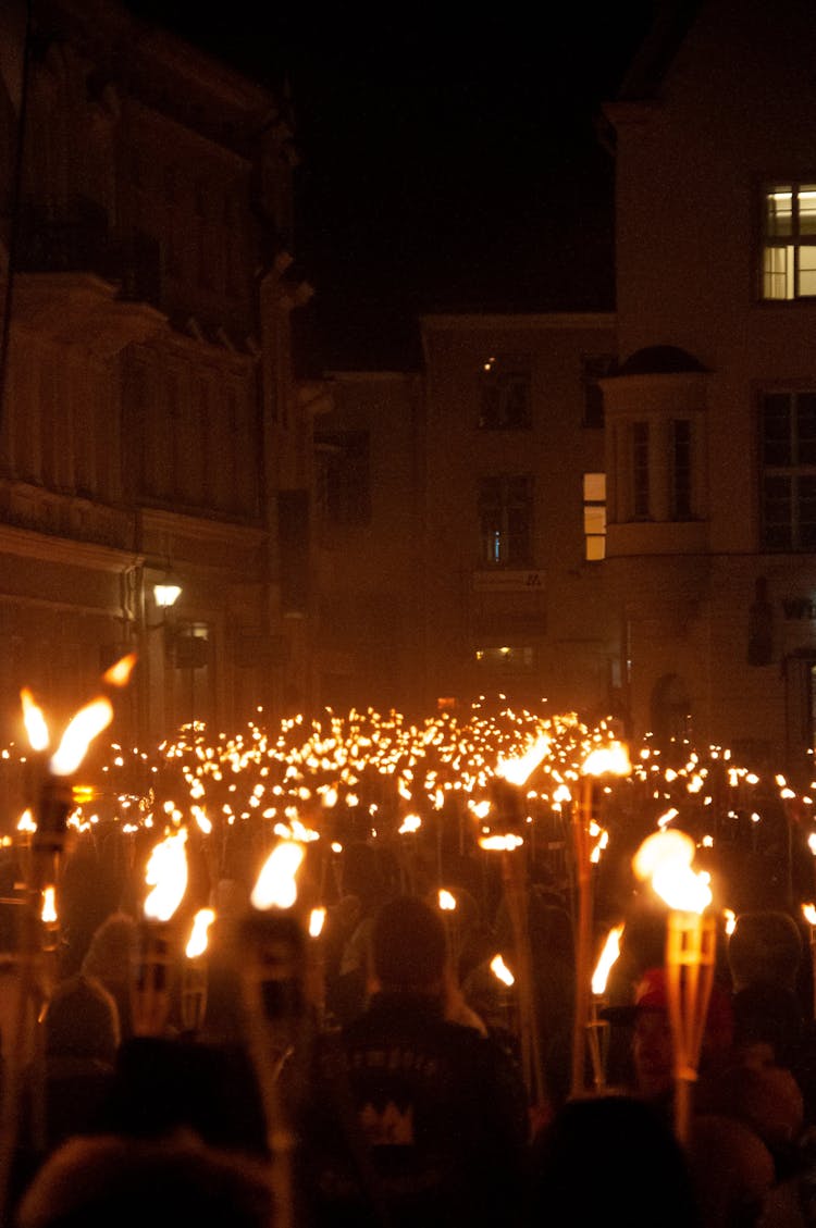 Torchlight Procession In City At Night