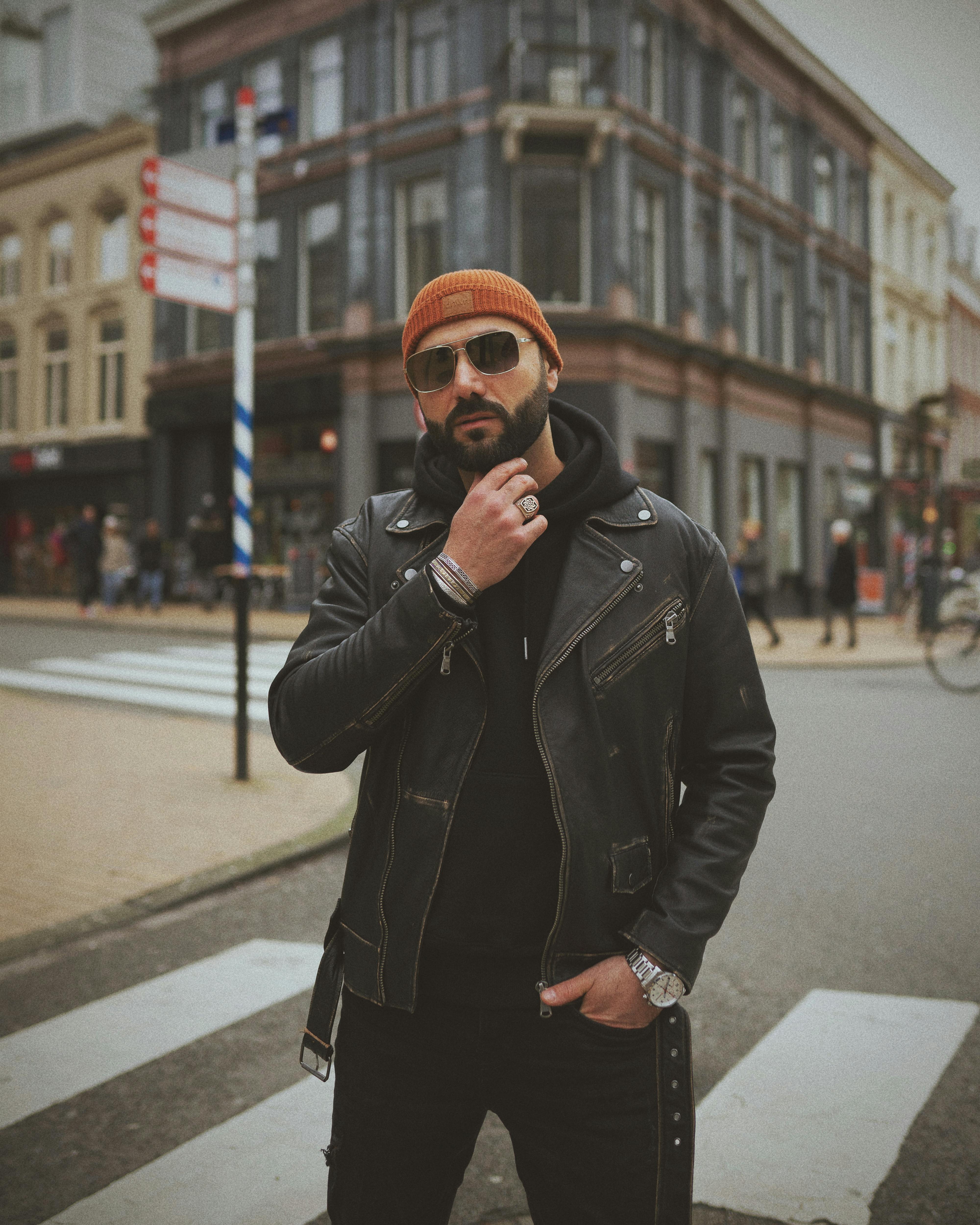 Brutal young man standing on street in city · Free Stock Photo