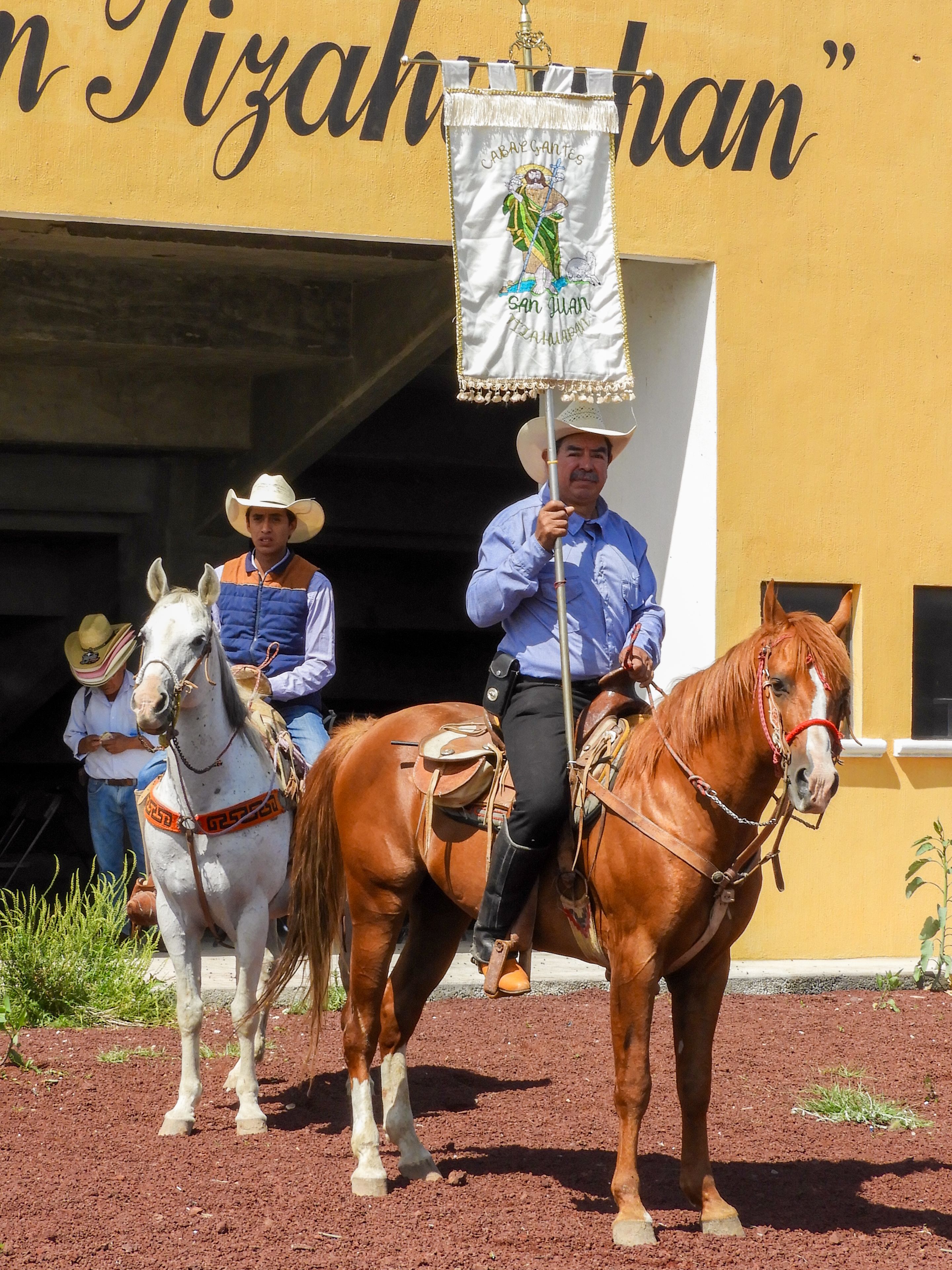 Mexican charros participate in a traditional parade, showcasing cultural heritage and horsemanship.