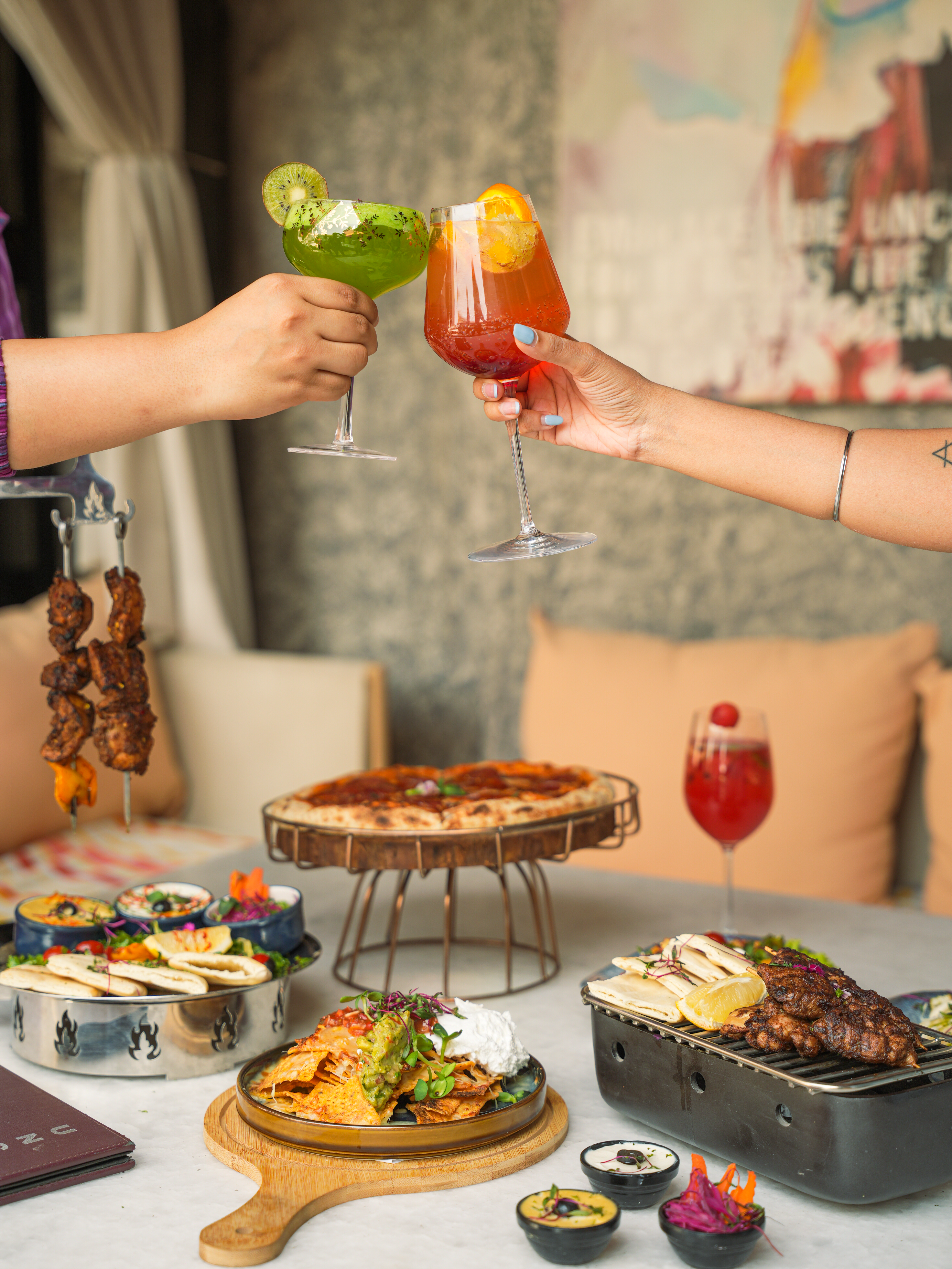 Celebrate with a vibrant table of cocktails and diverse cuisine.