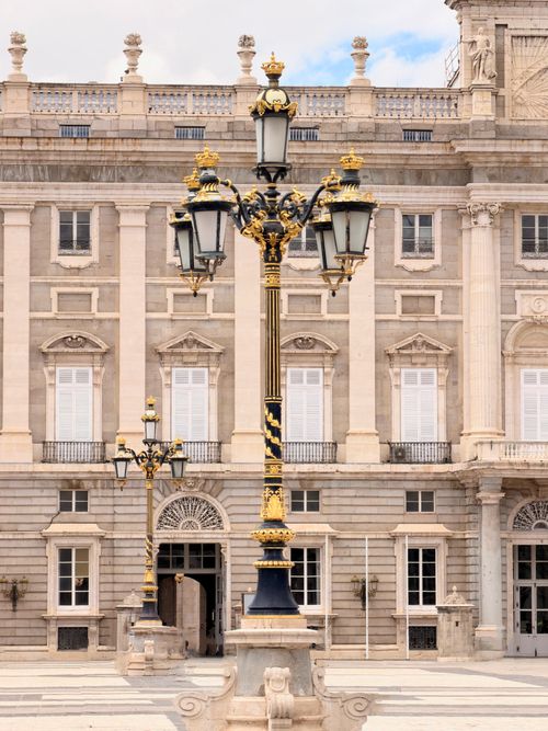 Free Ornate lamp post with gold details in front of Madrid's Royal Palace, Spain. Stock Photo