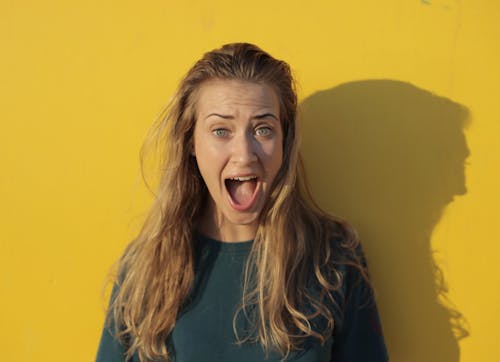 Excited woman screaming and looking at camera