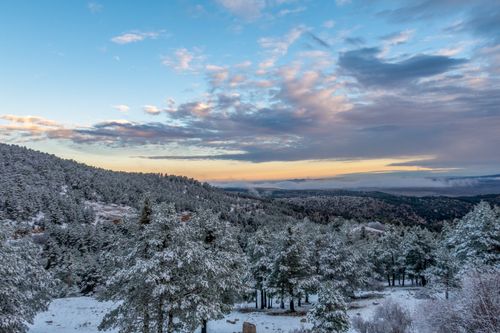 Free Breathtaking winter landscape of snowy forest and mountains in Aragón, Spain at sunset. Stock Photo