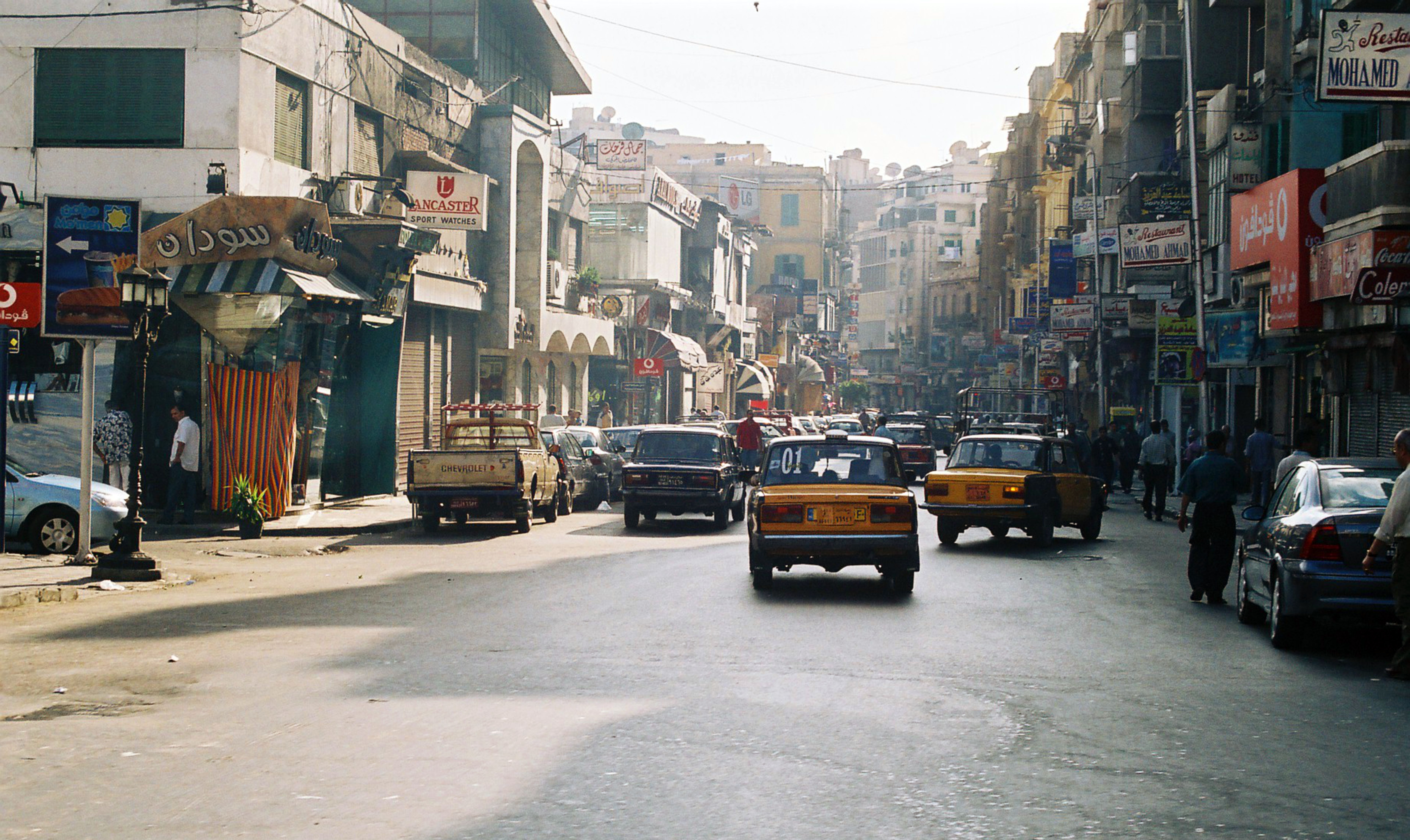 Busy pedestrian street in central Luxor with shops and cafés