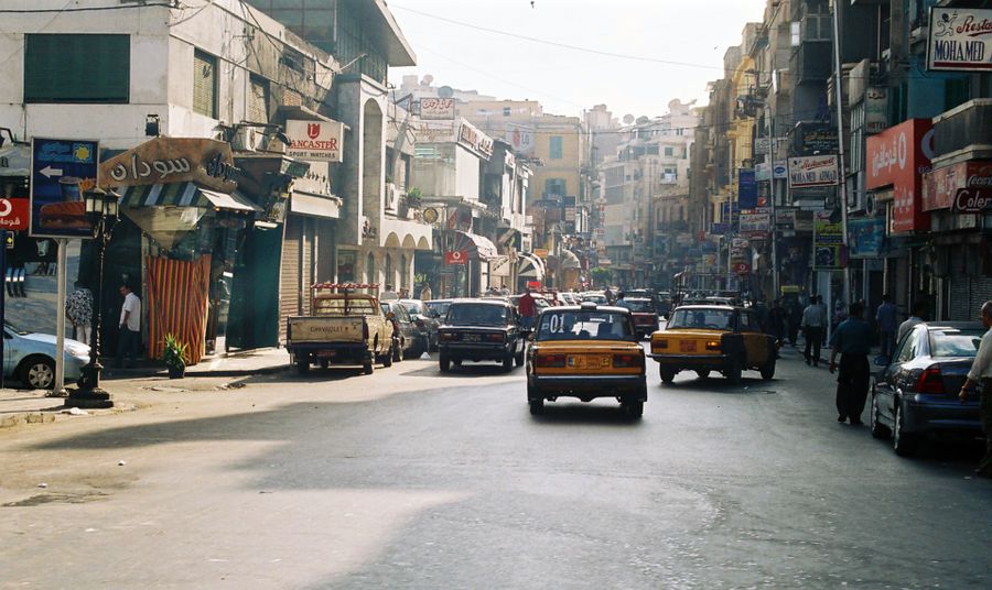 Busy pedestrian street in central Luxor with shops and cafés