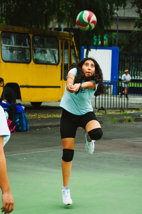 Free Young woman playing volleyball on an outdoor court in Mexico City. Stock Photo