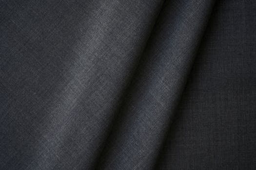 Close-up of elegant black textile fabric with fine texture and pattern, perfect for fashion design.