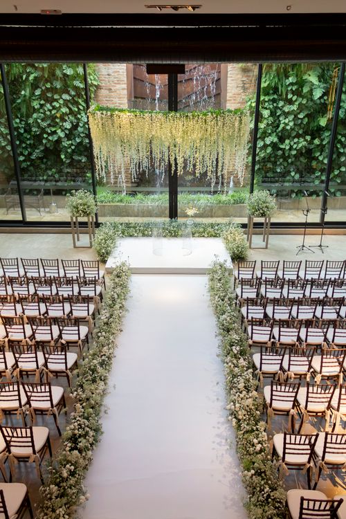 Free Beautiful indoor wedding setup with white flowers and chairs in São Paulo, Brazil. Stock Photo
