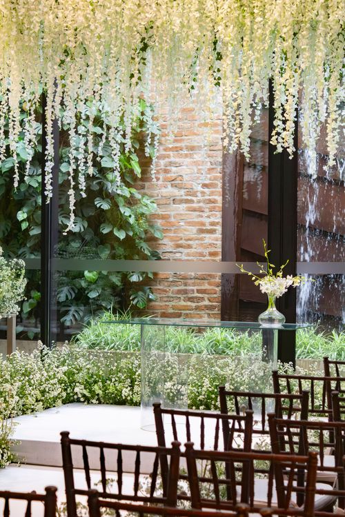 Free Beautiful indoor wedding setting with elegant floral decor and natural greenery. Stock Photo
