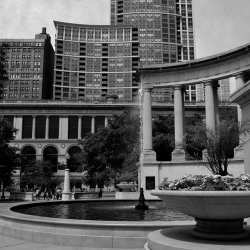 Free Elegant black and white image of a fountain in Grant Park with urban skyscrapers in the background. Stock Photo