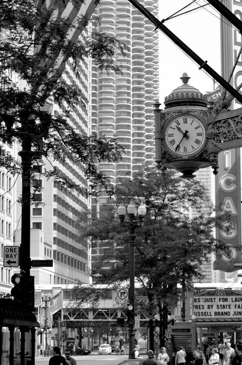 Free Black and white cityscape featuring Chicago theatre sign, clock, and urban architecture. Stock Photo