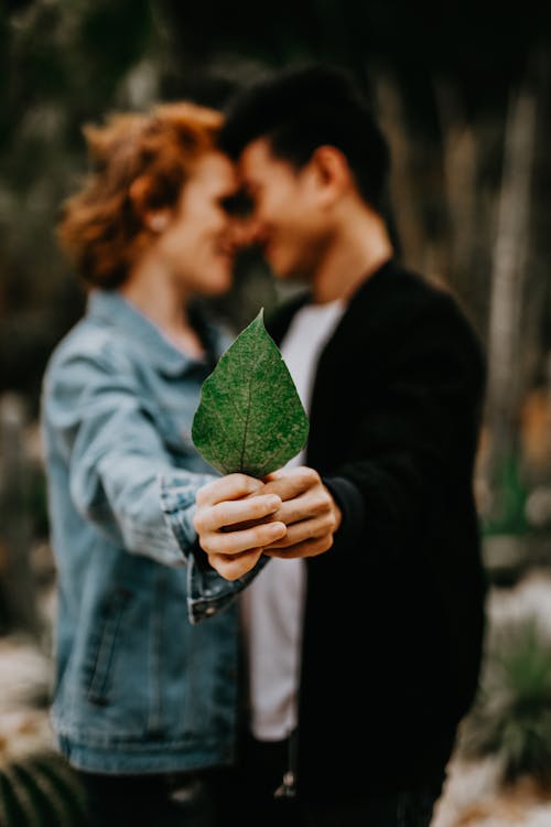 A Couple Holding a Leaf Together