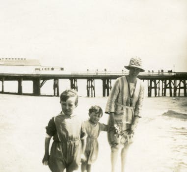 A classic vintage photo of a family enjoying a day by the beach pier.