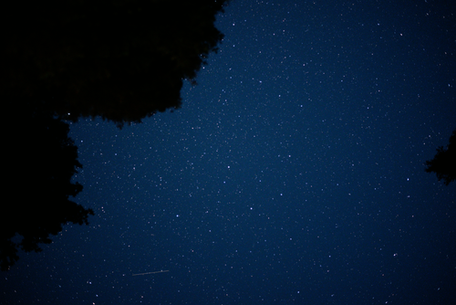 Free A stunning view of a star-filled night sky and shooting star. Stock Photo