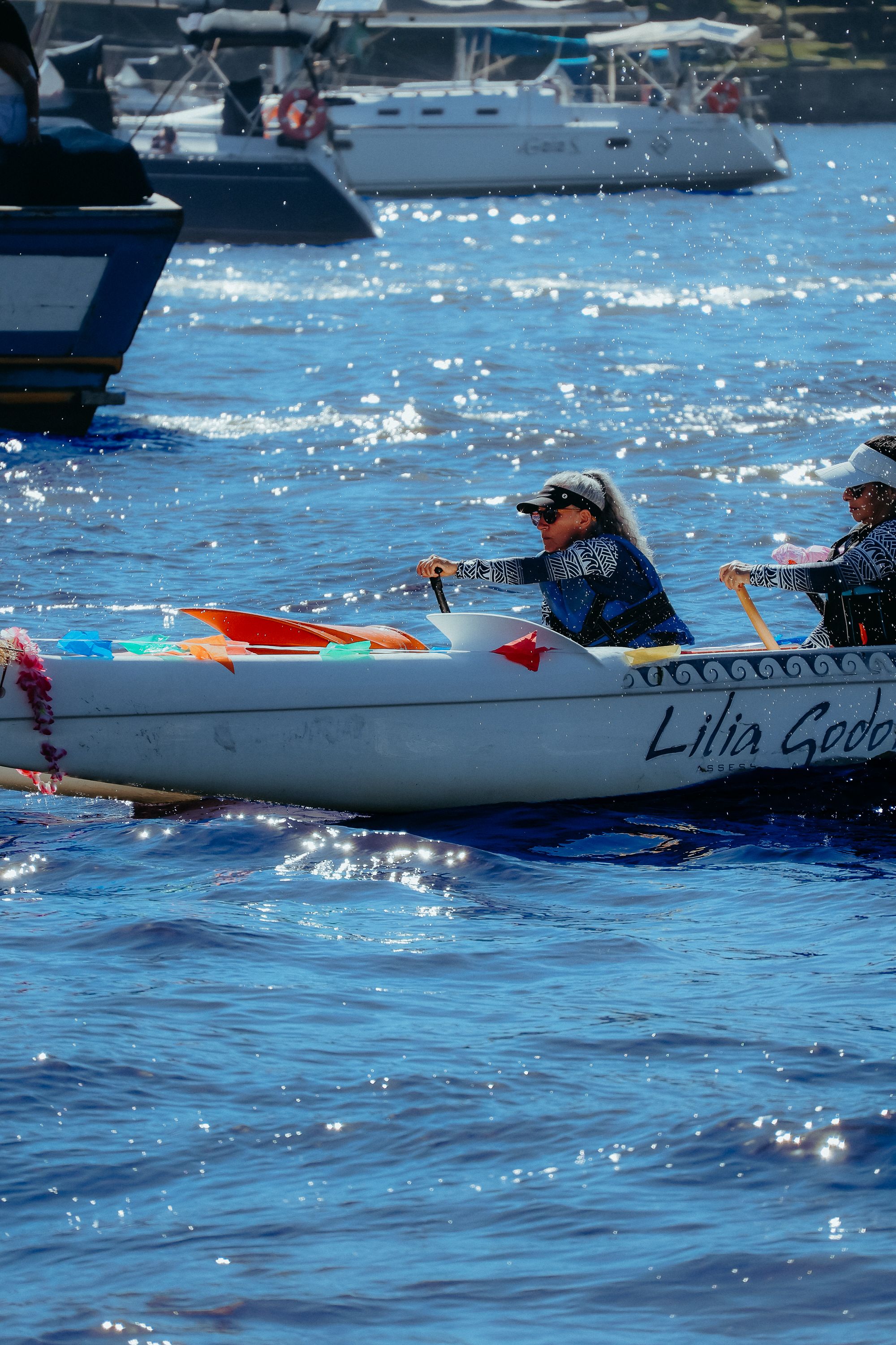 Colorful canoe race on a sunny day in Rio's waters, capturing lively energy and teamwork.