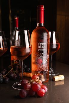 A sophisticated still life featuring Verano blush wine, glasses, and grapes, ideal for food photography enthusiasts.