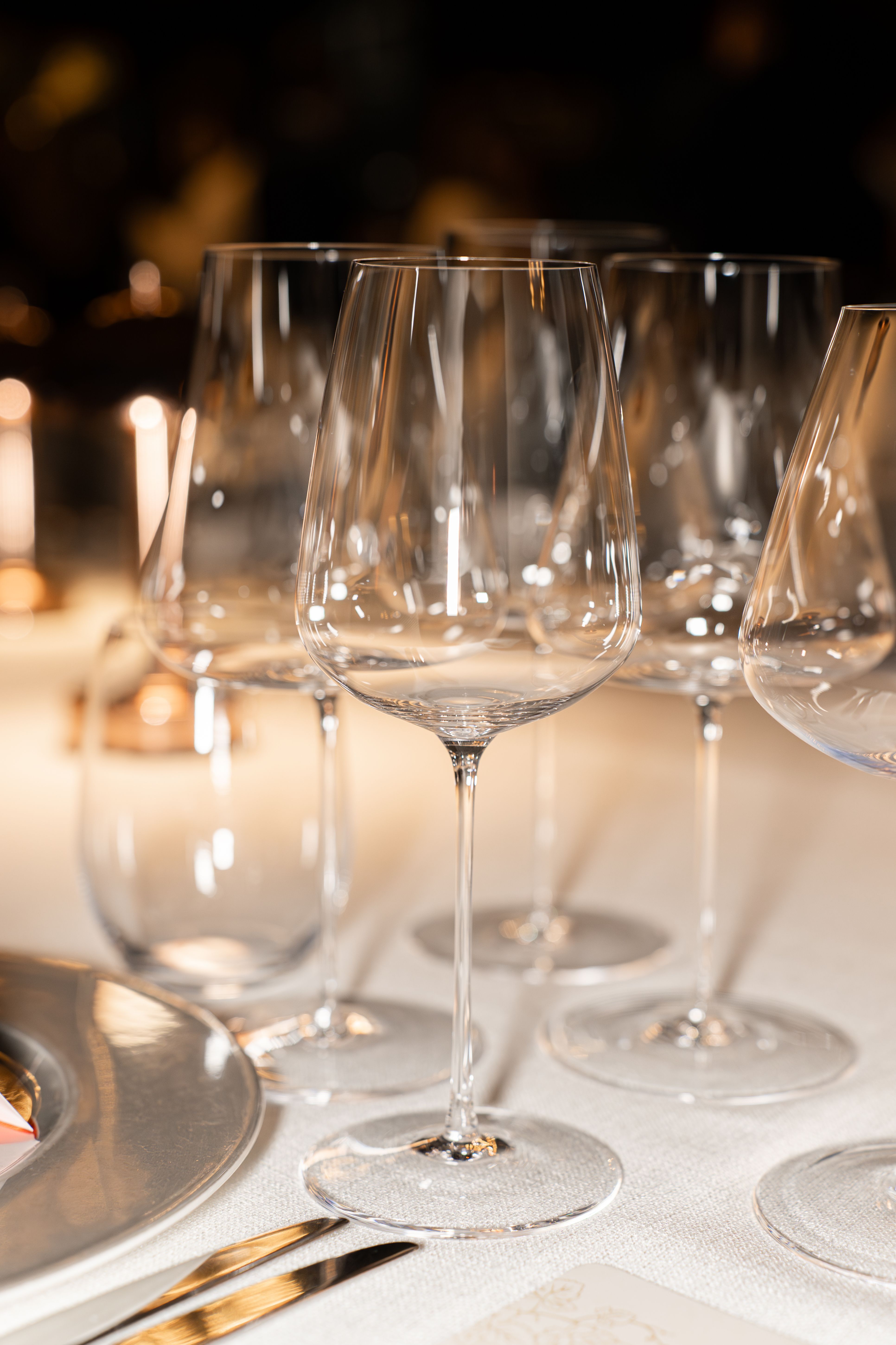 Close-up of elegant wine glasses set on a sophisticated dining table, creating a luxurious ambience.