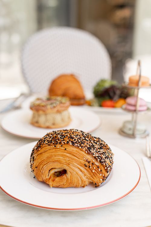 Free Close-up of a sesame pastry on a white plate in a cafe. Perfect for food enthusiasts and bakery lovers. Stock Photo