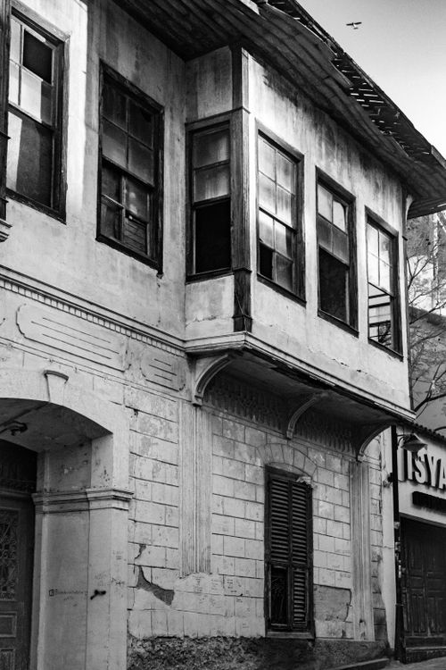 Free A grayscale image of an old, weathered building showcasing traditional architecture. Stock Photo