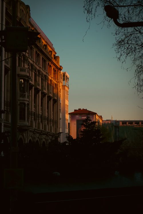 Free Beautiful sunset lighting enhances old European architecture in a cityscape. Stock Photo